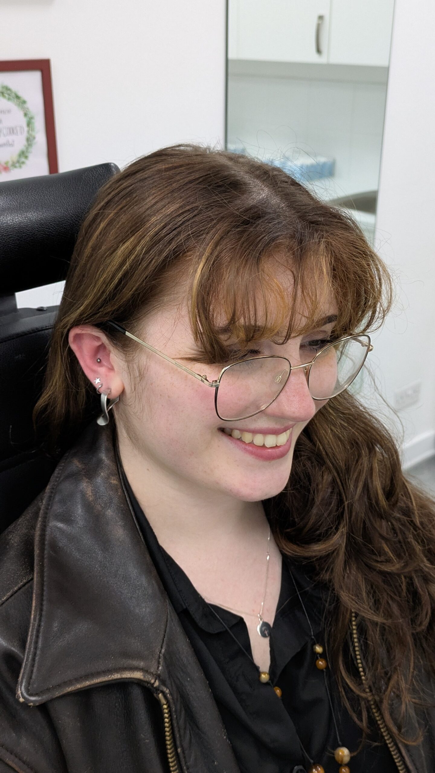 A smiling customer with a new flat piercing