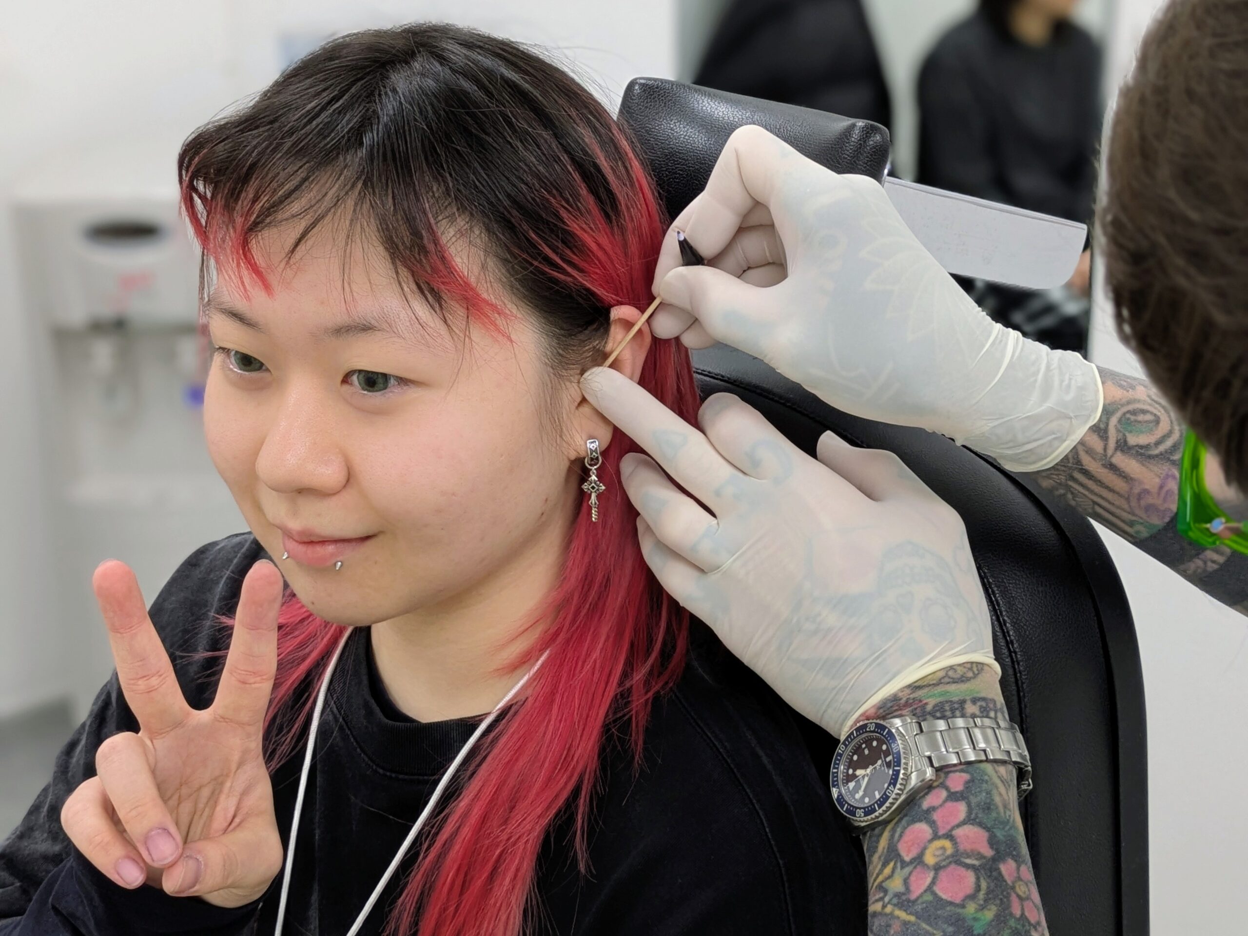 AJ Measuring a new helix piercing at Metal Fatigue Piercing Studio, Bournemouth