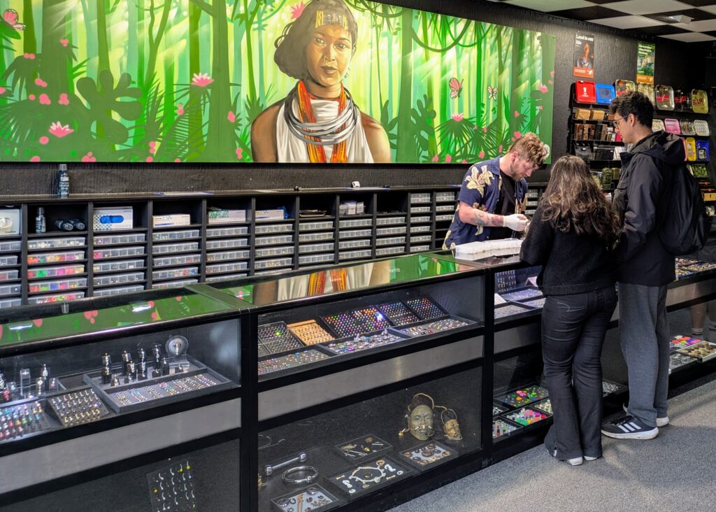 Will advising a couple on new body jewellery at Paradox Body Jewellery, Bournemouth, Dorset